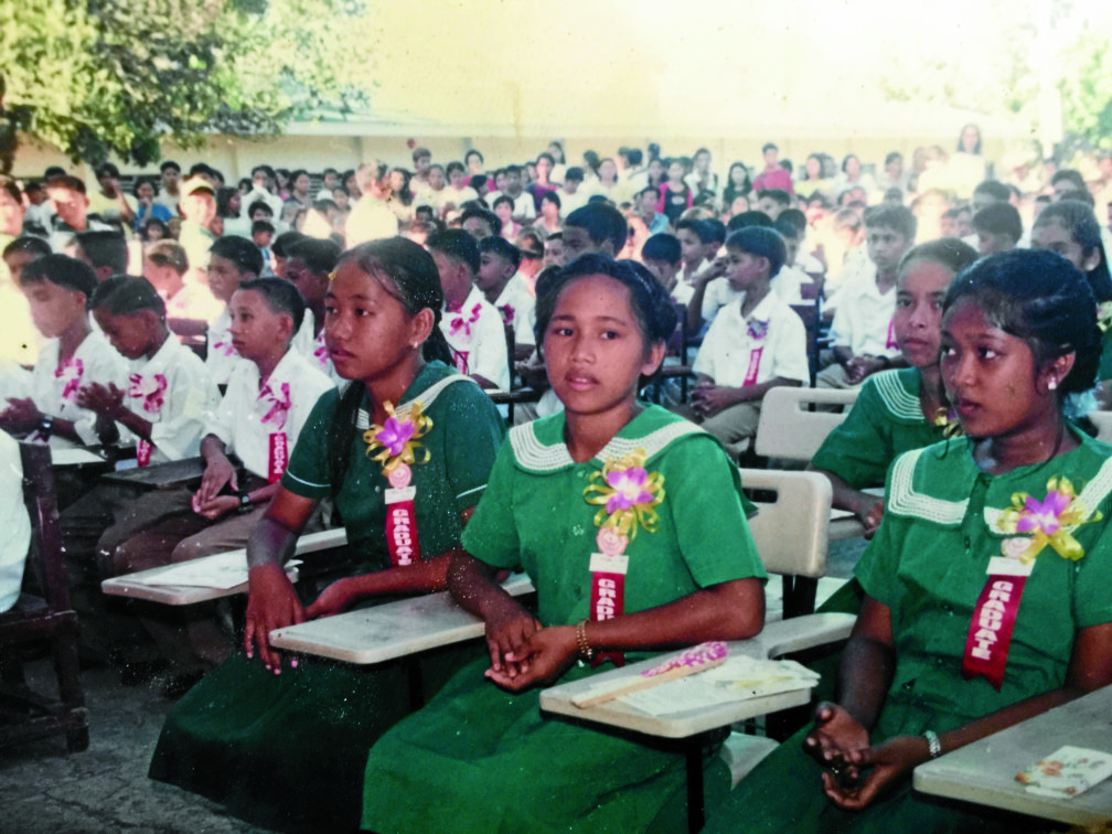 At age of 12, Hidilyn Diaz graduated  from her primary education at Mampang Elementary School. Diaz wearing a green graduation dress. In her younger days, Hidilyn Diaz already tried bigger weights beyond her weight. REPRODUCTION PHOTO BY JULIE ALIPALA
