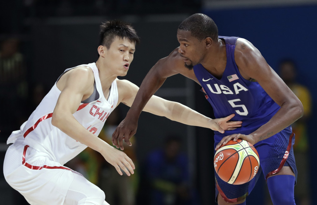 United States' Kevin Durant (5) drives past China's Zou Peng, left, during a basketball game at the 2016 Summer Olympics in Rio de Janeiro, Brazil, Saturday, Aug. 6, 2016. (AP Photo/Charlie Neibergall)