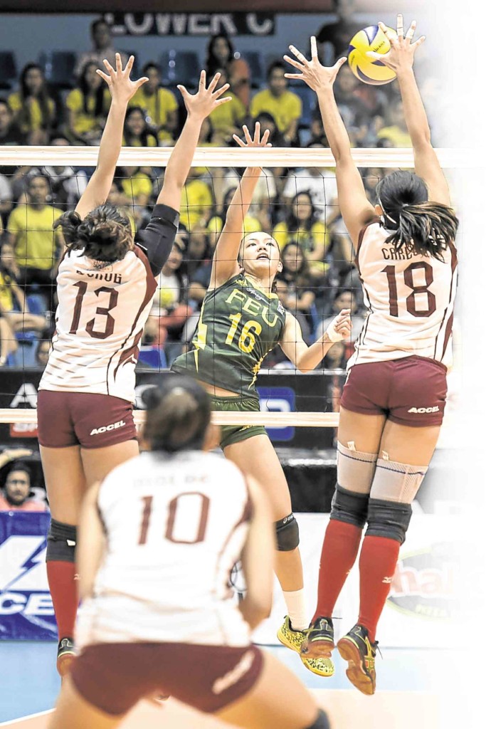TONI Rose Basas of Far Eastern University fails to score against University of Philippines’  Justine Dorog (left) and Diana Mae Carlos during their Shakey’s V-League match yesterday.  sherwin vardeleon