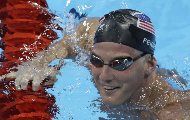 FILE - In this Aug. 2, 2016, file photo, U.S. swimmer James Feigen smiles during a swimming training session prior to the 2016 Summer Olympics in Rio de Janeiro, Brazil. Feigen apologized for the "serious distraction" he and three teammates caused at a gas station during the Rio Olympics, saying he omitted facts in his statement to police. Feigen says in a statement posted Tuesday, Aug. 23, 2016,  on the website of his lawyer in Austin, Texas, that "I omitted the facts that we urinated behind the building and that Ryan Lochte pulled a poster off the wall." (AP Photo/Matt Slocum, File)