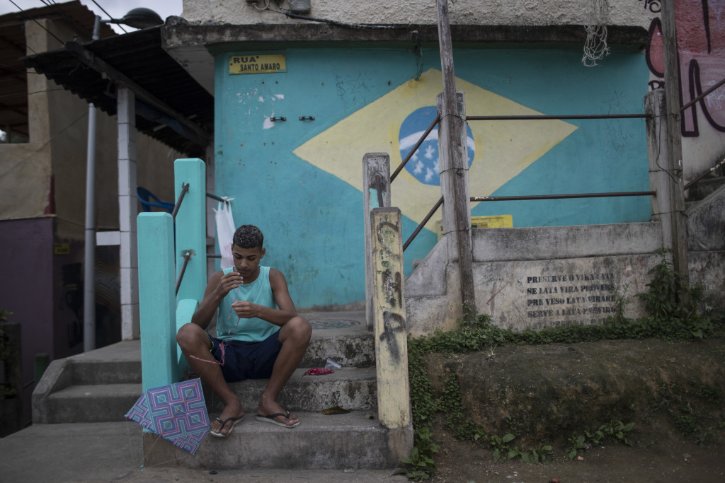 A Boy prepares his kite before flying it at the Babilonia slum in Rio de Janeiro, Brazil, Wednesday, Aug. 3, 2016. The Olympics are scheduled to open Aug. 5. (AP Photo/Felipe Dana)