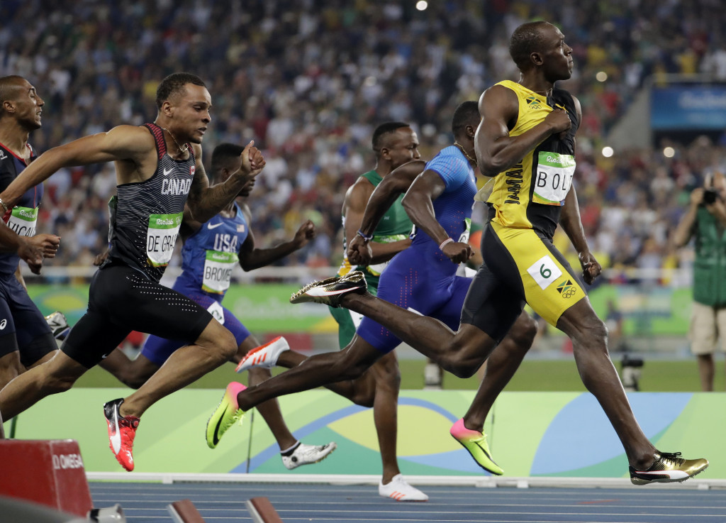 Jamaica's Usain Bolt celebrates as he crosses the line to win gold in the men's 100-meter final during the athletics competitions of the 2016 Summer Olympics at the Olympic stadium in Rio de Janeiro, Brazil, Sunday, Aug. 14, 2016. (AP Photo/David Goldman)