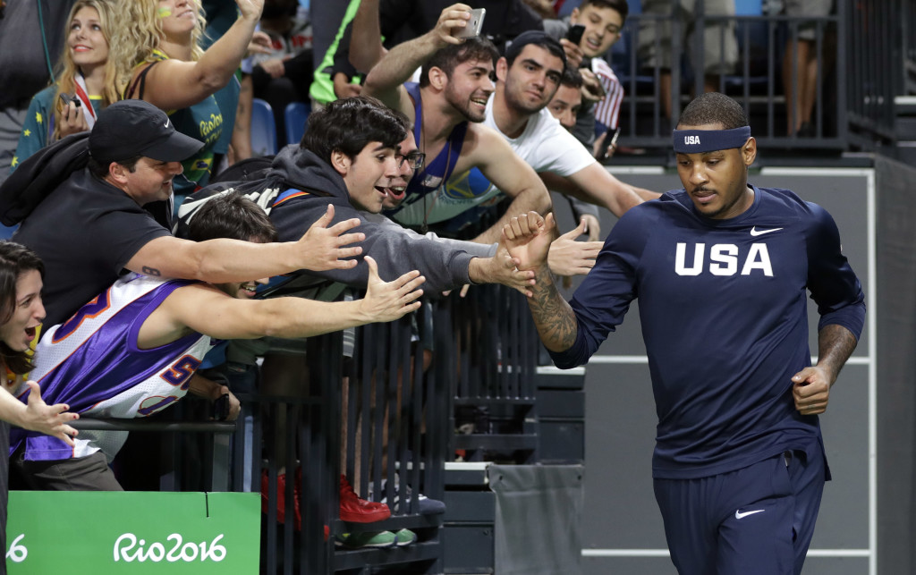 Fans reach out to United States' Carmelo Anthony, right, as he enters the arena for a men's basketball game against Australia at the 2016 Summer Olympics in Rio de Janeiro, Brazil, Wednesday, Aug. 10, 2016. (AP Photo/Eric Gay)