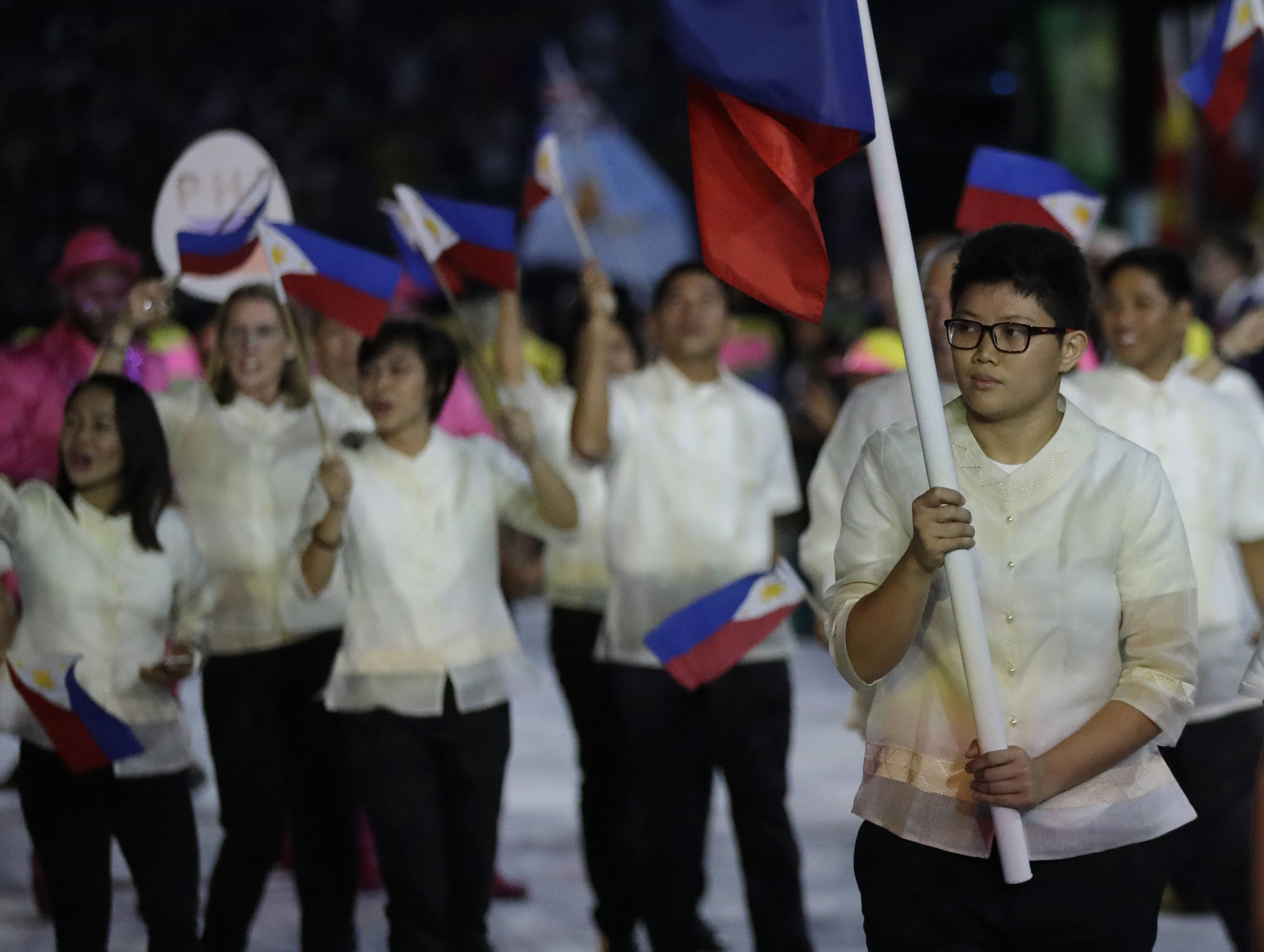 Ian Lariba carries the flag of the Philippines during the opening ceremony for the 2016 Summer Olympics in Rio de Janeiro, Brazil, Friday, Aug. 5, 2016. (AP Photo/David Goldman)