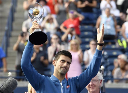 Novak Djokovic, of Serbia, salutes the spectators while holding the trophy after his win over Kei Nishikori, of Japan, in the final of the Rogers Cup tennis tournament, Sunday, July 31, 2016, in Toronto. Djokovic won 6-3, 7-5.(Frank Gunn/The Canadian Press via AP)