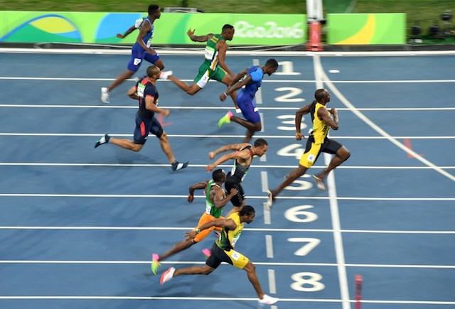 (From bottom) Jamaica's Yohan Blake, Ivory Coast's Ben Youssef Meite, Canada's Andre De Grasse, Jamaica's Usain Bolt, France's Jimmy Vicaut, USA's Justin Gatlin, South Africa's Akani Simbine and USA's Trayvon Bromell cross the finish line of the Men's 100m Final during the athletics event at the Rio 2016 Olympic Games at the Olympic Stadium in Rio de Janeiro on August 14, 2016.   / AFP PHOTO / ERIC FEFERBERG