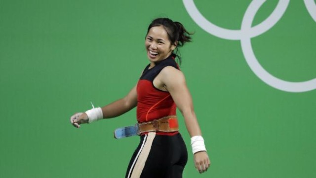 Hidilyn Diaz, of the Philipines, laughs as she leaves the stage after a lift in the women's 53kg weightlifting competition at the 2016 Summer Olympics in Rio de Janeiro, Brazil, Sunday, Aug. 7, 2016. AP
