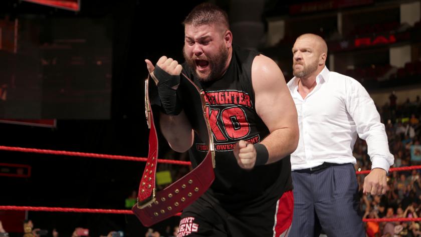 Kevin Owens celebrates his newly won WWE Universal Championship as Triple H looks on. Photo by WWE.com