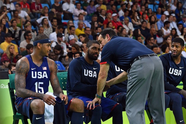 USA's head coach Mike Krzyzewski (Front R) talks with USA's forward Carmelo Anthony (L), USA's guard Kyrie Irving (C) and USA's guard Paul George on the bench in the fourth quarter of a Men's Gold medal basketball match between Serbia and USA at the Carioca Arena 1 in Rio de Janeiro on August 21, 2016 during the Rio 2016 Olympic Games. / AFP PHOTO / Andrej ISAKOVIC