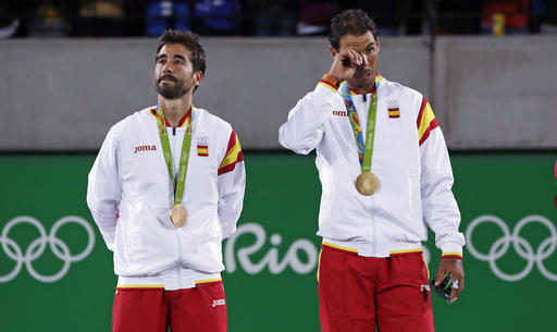 Rafael Nadal, right, and partner Marc Lopez, of Spain, stand during the awards ceremony after winning the gold medal in men's doubles at the 2016 Summer Olympics in Rio de Janeiro, Brazil, Friday, Aug. 12, 2016. AP Photo