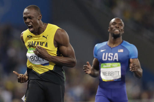 Usain Bolt from Jamaica, left, celebrates winning the gold medal in the men's 200-meter final during the athletics competitions of the 2016 Summer Olympics at the Olympic stadium in Rio de Janeiro, Brazil, Thursday, Aug. 18, 2016. AP Photo