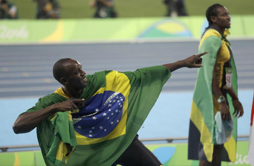 Jamaica's Usain Bolt holds the flag of Brazil after winning the gold medal in the men's 4x100-meter relay final during the athletics competitions of the 2016 Summer Olympics at the Olympic stadium in Rio de Janeiro, Brazil, Friday, Aug. 19, 2016. AP Photo