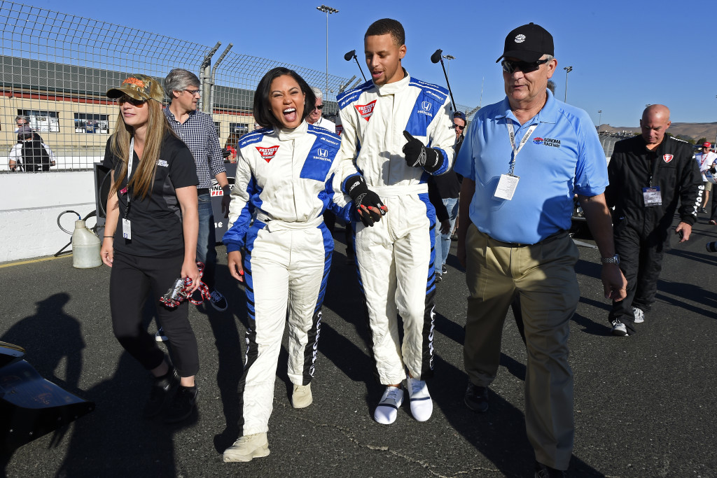 NBA basketball player Stephen Curry and his wife Ayesha Curry talk about their ride after experiencing a lap in a IndyCar driven by Mario Andretti before the Indy Grand Prix of Sonoma. AP