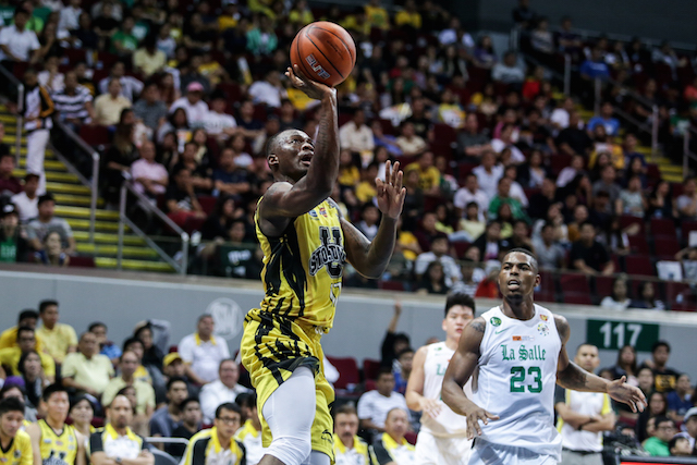 In this file photo, UST's William Afoakwah attempts a one-hander as La Salle's Ben Mbala looks on. Tristan Tamayo/INQUIRER.net