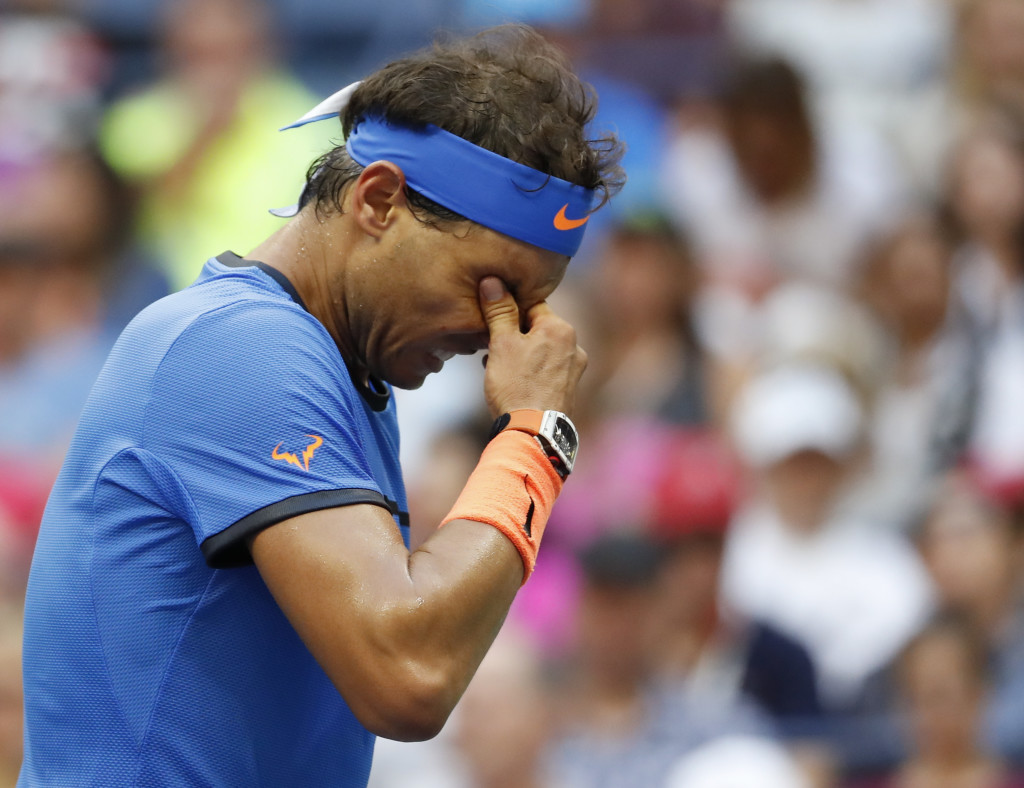 Rafael Nadal, of Spain, rubs his eyes during play against Lucas Pouille, of France, during the fourth round of the U.S. Open tennis tournament, Sunday, Sept. 4, 2016, in New York. (AP Photo/Alex Brandon)