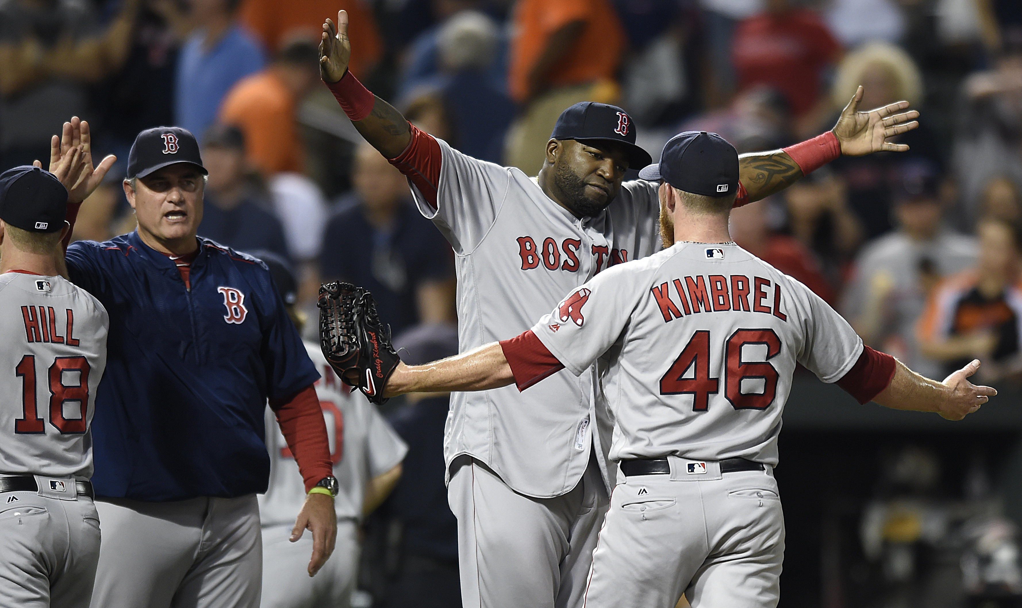 Boston Red Sox designated hitter David Ortiz, center hugs closing pitcher Craig Kimbrel after defeating the Baltimore Orioles 5-3 in a baseball game to sweep a four game series, Thursday, Sept.. 22, 2016, in Baltimore. (AP Photo/Gail Burton)