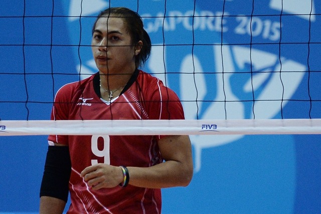 Aprilia Santini Manganang of Indonesia watches a serve against Philippines in the women's volleyball preliminary match during the 28th Southeast Asian Games (SEA Games) in Singapore on June 10, 2015. AFP PHOTO / MANAN VATSYAYANA