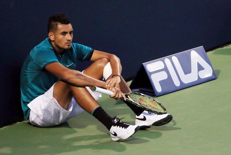 (FILES) This file photo taken on July 25, 2016 in Toronto, shows Nick Kyrgios of Australia sitting at the end of the court as he waits for the final game in his match against Denis Shapovalov of Canada during Day 1 of the Rogers Cup at the Aviva Centre.    Wayward tennis star Nick Kyrgios will seek psychological help to avoid an eight week ban ordered by the ATP for a tantrum at the Shanghai Masters, Tennis Australia said on October 17, 2016. / AFP PHOTO / GETTY IMAGES NORTH AMERICA / Vaughn  Ridley
