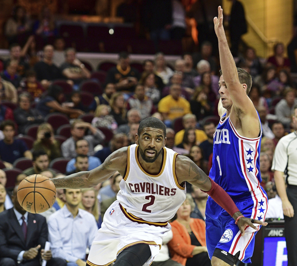 Cleveland Cavaliers guard Kyrie Irving (2) drives on Philadelphia 76ers T.J. McConnell (1) in the first half of an NBA preseason basketball game Saturday, Oct. 8, 2016, in Cleveland. (AP Photo/David Dermer)