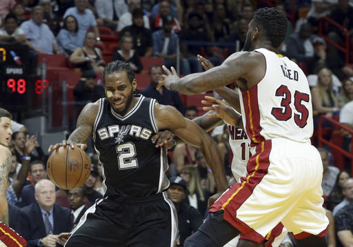 San Antonio Spurs' Kawhi Leonard (2) drives to the basket as Miami Heat's Dion Waiters (11) and Willie Reed (35) defend during the second half of an NBA basketball game, Sunday, Oct. 30, 2016, in Miami. The Spurs defeated the Heat 106-99. AP Photo