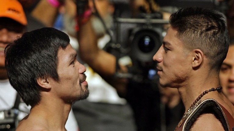 Boxers Manny Pacquiao, Philippines, and Jessie Vargas, USA, face off during their official weigh-in at the Wynn Las Vegas hotel in Las Vegas, Nevada on November 4, 2016.   Pacquiao will challenge Vargas for the WBO Welterweight Title Saturday, November 5, 2016 at the Thomas & Mack Center.  / AFP PHOTO / John GURZINSKI