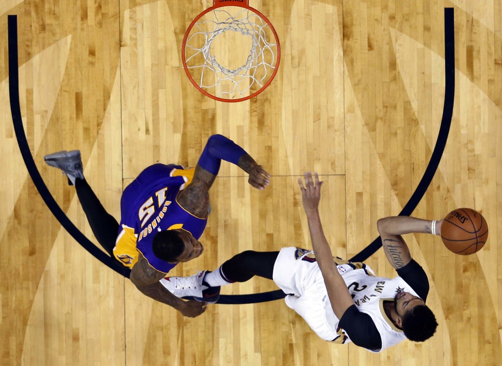 New Orleans Pelicans forward Anthony Davis (23) goes to the basket against Los Angeles Lakers forward Thomas Robinson (15) in the first half of an NBA basketball game in New Orleans, Saturday, Nov. 12, 2016. (AP Photo/Gerald Herbert)