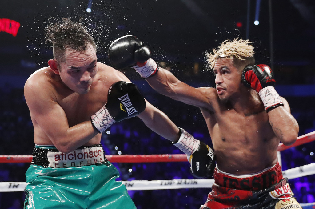 Jessie Magdaleno hits Nonito Donaire, of the Philippines, during their WBO junior featherweight title boxing match Saturday, Nov. 5, 2016, in Las Vegas. (AP Photo/Isaac Brekken)