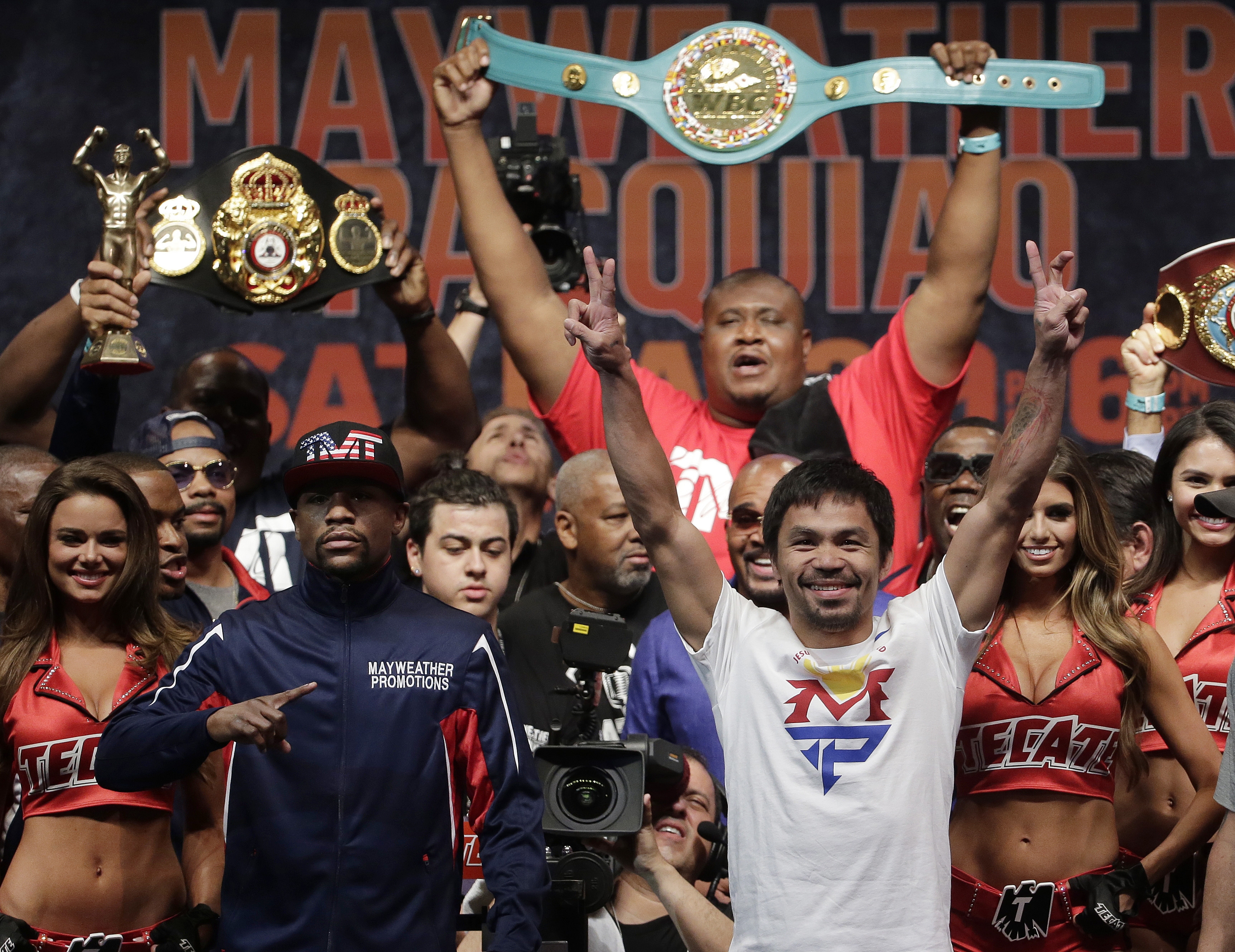 Floyd Mayweather Jr., left, and Manny Pacquiao pose during their weigh-in on Friday, May 1, 2015 in Las Vegas. The world weltherweight title fight between Mayweather Jr. and Pacquiao is scheduled for May 2. (AP Photo/Chris Carlson)