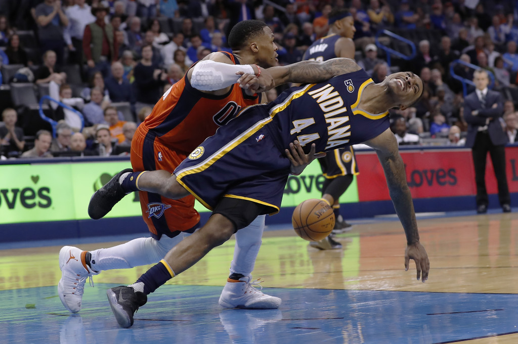 Oklahoma City Thunder guard Russell Westbrook (0) and Indiana Pacers guard Jeff Teague (44) get tangled up after a play during the second half of an NBA basketball game in Oklahoma City, Sunday, Nov. 20, 2016. Indiana won in overtime 115-111. (AP Photo/Alonzo Adams)