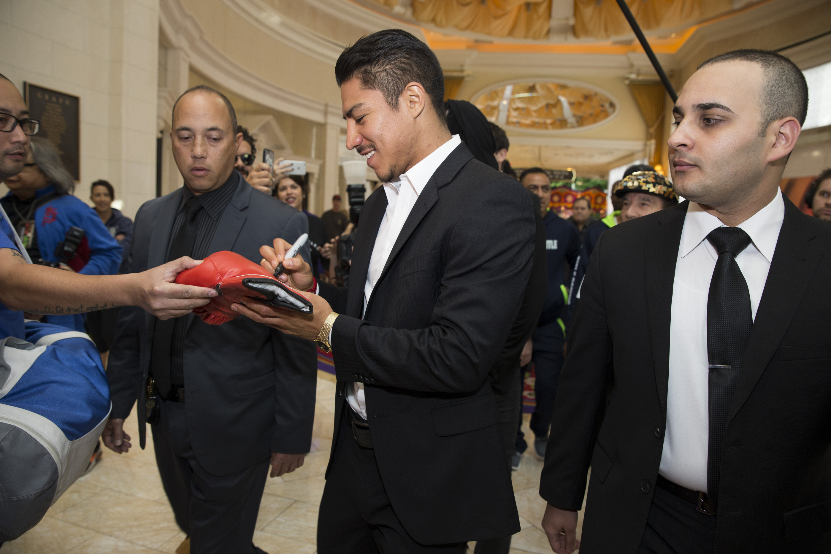 Boxer Jessie Vargas signs an autograph as he makes his "Grand Arrival" to the Wynn hotel-casino on Tuesday, Nov. 1, 2016, in Las Vegas. Vargas is scheduled to fight Manny Pacquiao  on Saturday night at the Thomas & Mack Center. (Erik Verduzco/Las Vegas Review-Journal via AP)