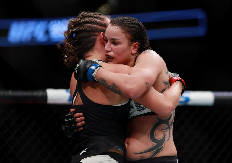 NEW YORK, NY - NOVEMBER 12: Miesha Tate of the United States (left) embraces Raquel Pennington of the United States after her unanimous decision defeat in their women's bantamweight bout during the UFC 205 event at Madison Square Garden on November 12, 2016 in New York City.   Michael Reaves/Getty Images /AFP
