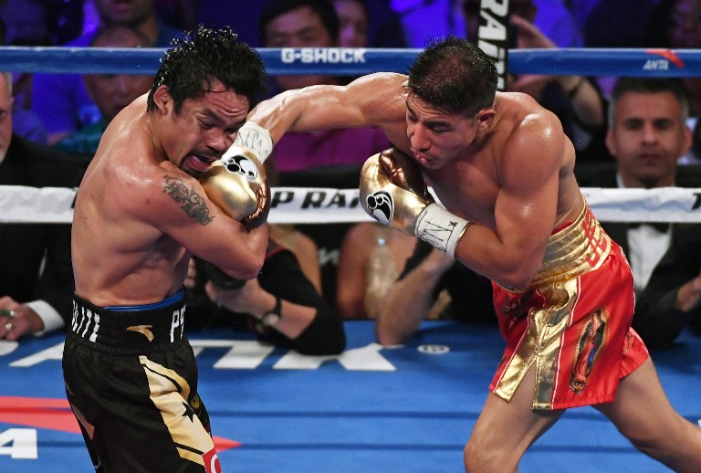 LAS VEGAS, NV - NOVEMBER 05: Jessie Vargas (R) hits Manny Pacquiao in the fourth round of their WBO welterweight championship fight at the Thomas & Mack Center on November 5, 2016 in Las Vegas, Nevada. Pacquiao won by unanimous decision.   Ethan Miller/Getty Images/AFP