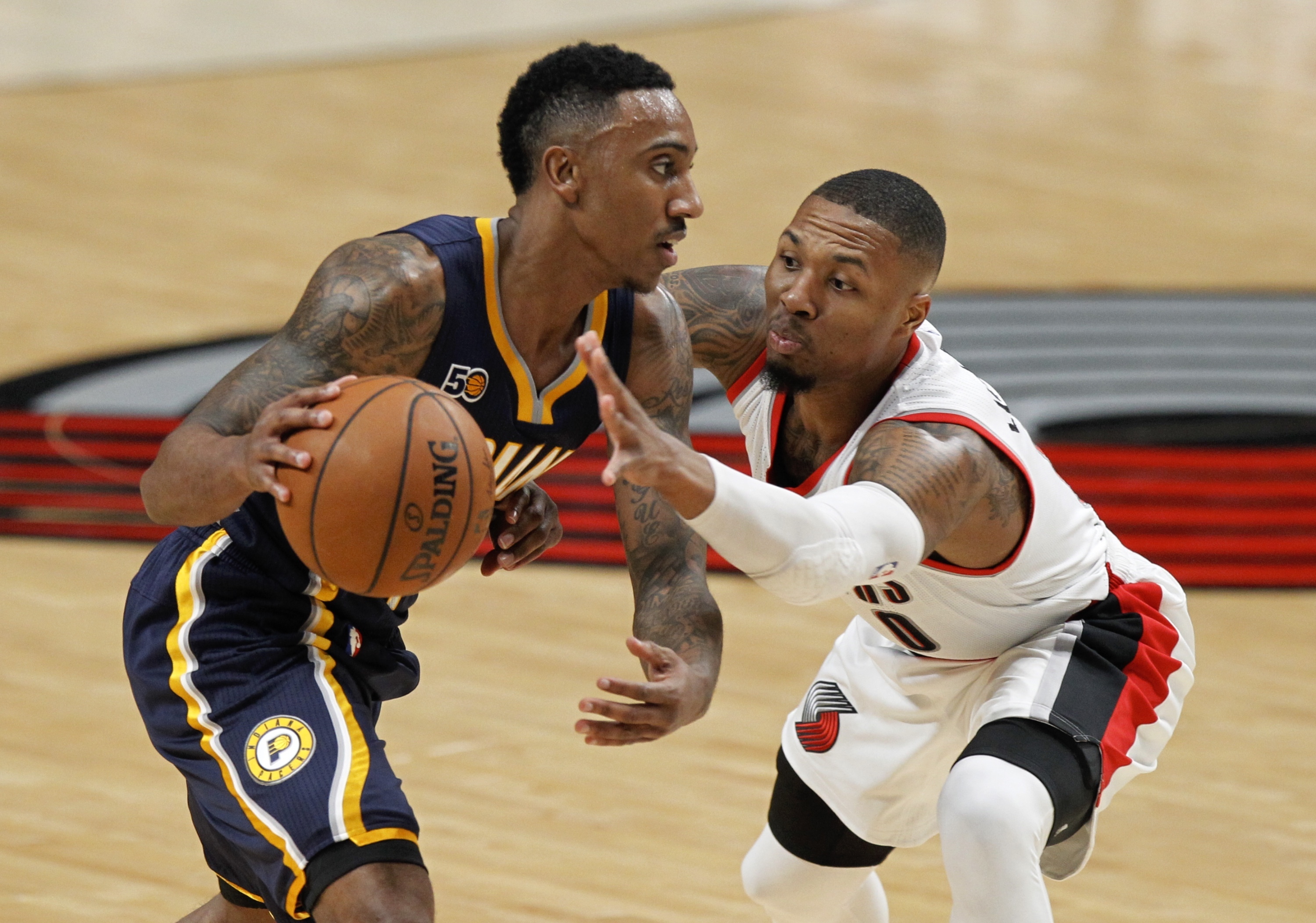 Indiana Pacers guard Jeff Teague, left, drives against Portland Trail Blazers guard Damian Lillard during the first half of an NBA basketball game in Portland, Ore., Wednesday, Nov. 30, 2016. AP
