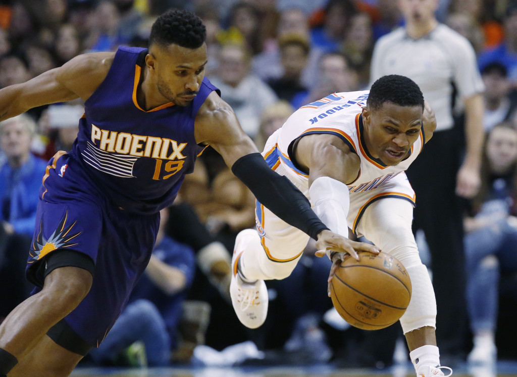 Phoenix Suns guard Leandro Barbosa (19) and Oklahoma City Thunder guard Russell Westbrook (0) reach for a loose ball in the fourth quarter of an NBA basketball game in Oklahoma City, Saturday, Dec. 17, 2016. Oklahoma City won 114-101. (AP Photo/Sue Ogrocki)