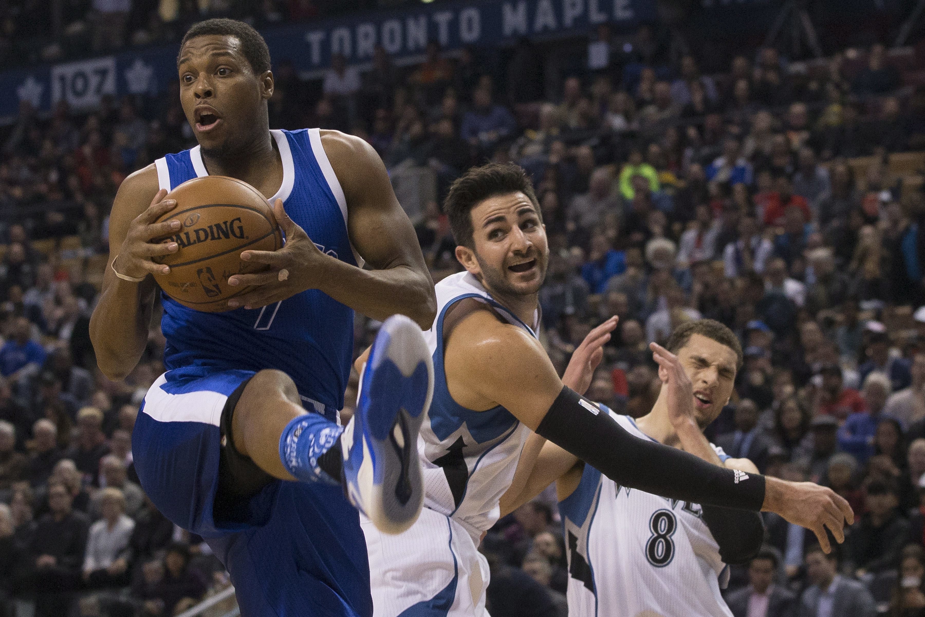 Toronto Raptors guard Kyle Lowry, from left, collects a rebound in front of Minnesota Timberwolves Ricky Rubio and Zach LaVine during the first half of an NBA basketball game in Toronto on Thursday, Dec. 8, 2016. AP