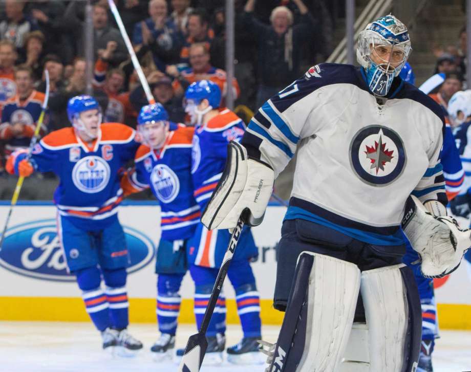 Winnipeg Jets goalie Connor Hellebuyck (37) reacts after letting in an Edmonton Oilers goal during the third period of an NHL hockey game in Edmonton, Alberta, Sunday, Dec. 11, 2016. (Amber Bracken/The Canadian Press via AP)