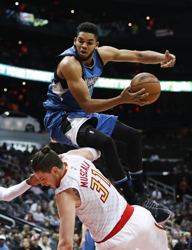 Minnesota Timberwolves center Karl-Anthony Towns (32) is fouled by Atlanta Hawks forward Mike Muscala (31) as he drives to the basket. AP