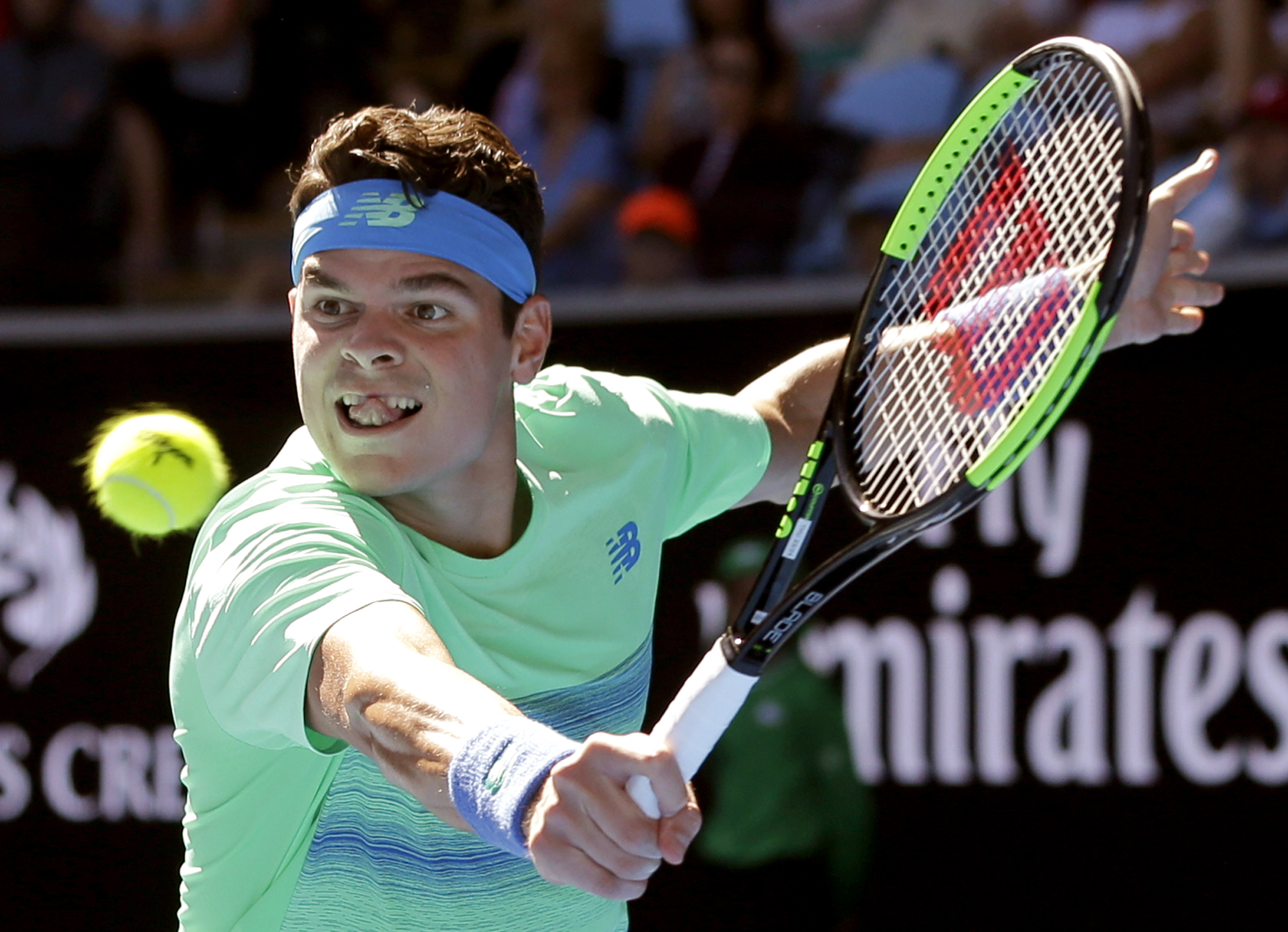Canada's Milos Raonic makes a backhand return to Luxembourg's Gilles Muller during their second round match at the Australian Open tennis championships in Melbourne, Australia, Thursday, Jan. 19, 2017. (AP Photo/Aaron Favila)