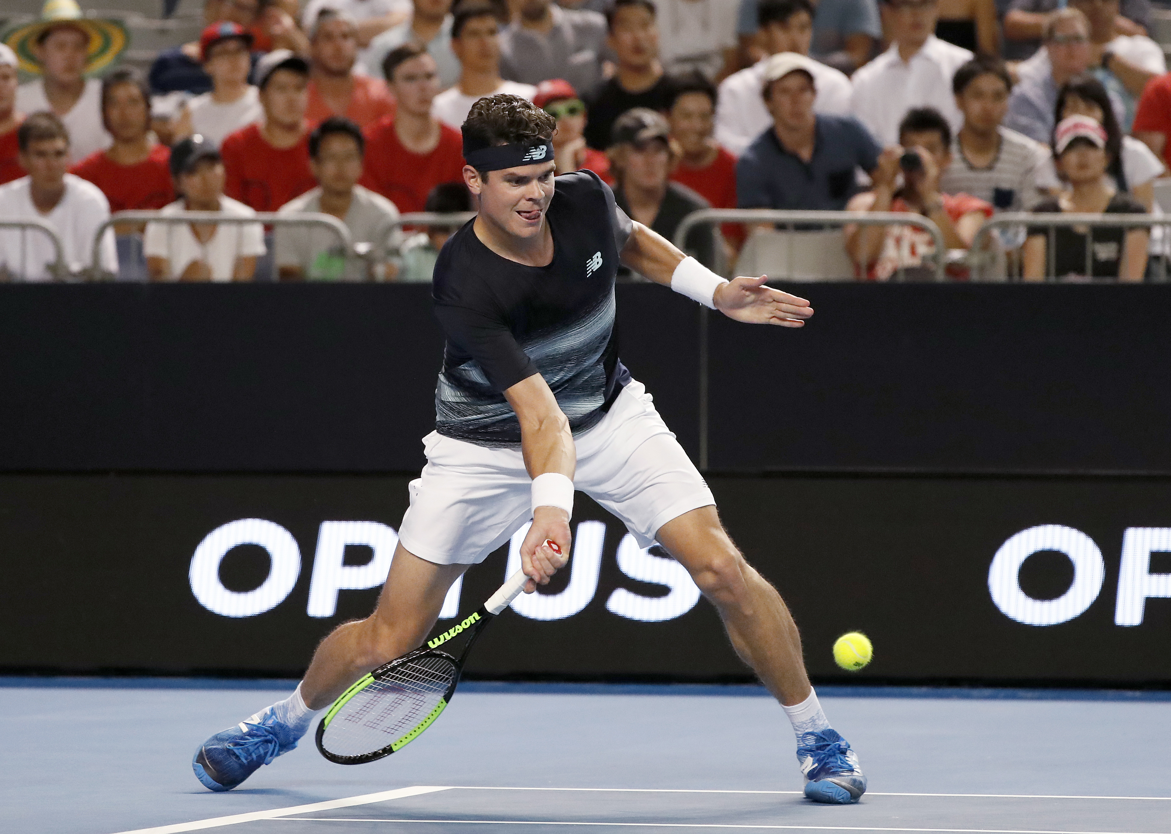Canada's Milos Raonic plays a low forehand to Spain's Roberto Bautista Agut during their fourth round match at the Australian Open tennis championships in Melbourne, Australia, Monday, Jan. 23, 2017. (AP Photo/Dita Alangkara)