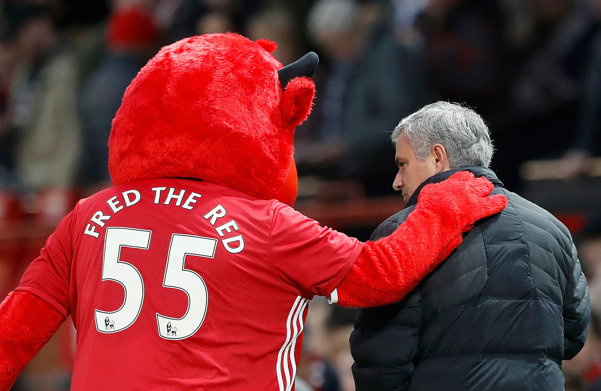 Manchester United mascot Fred The Red talks to manager Jose Mourinho during their English Premier League soccer match against Middlesborough at Old Trafford, Manchester, England, Saturday, Dec. 31, 2016, AP