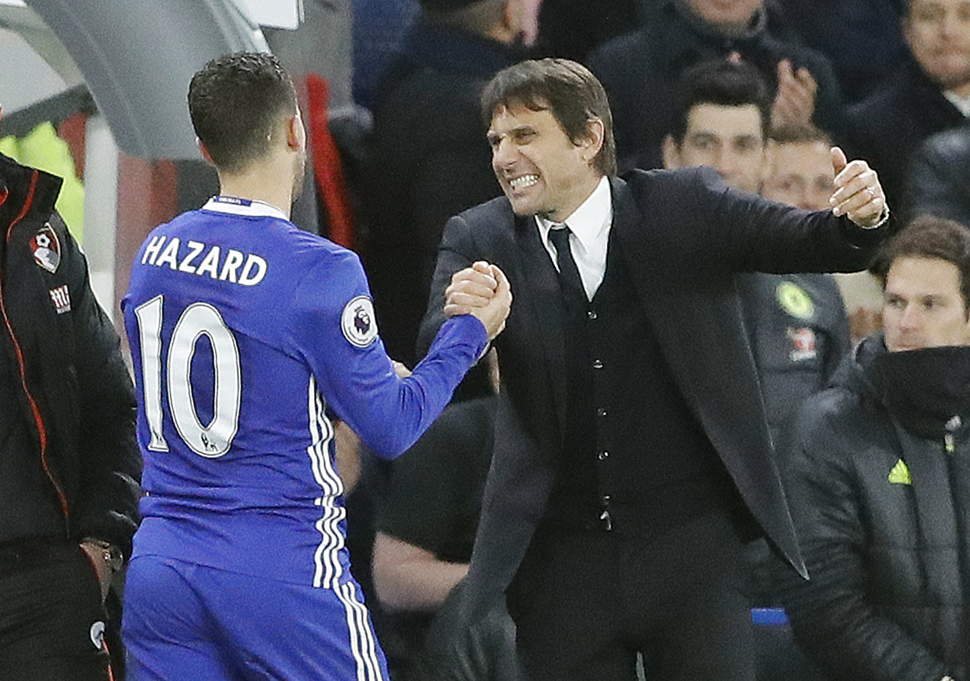 Chelsea's Eden Hazard, left, and Chelsea's team manager Antonio Conte celebrate after winning the English Premier League soccer match between Chelsea and Bournemouth at Stamford Bridge stadium in London, Monday, Dec. 26, 2016. AP