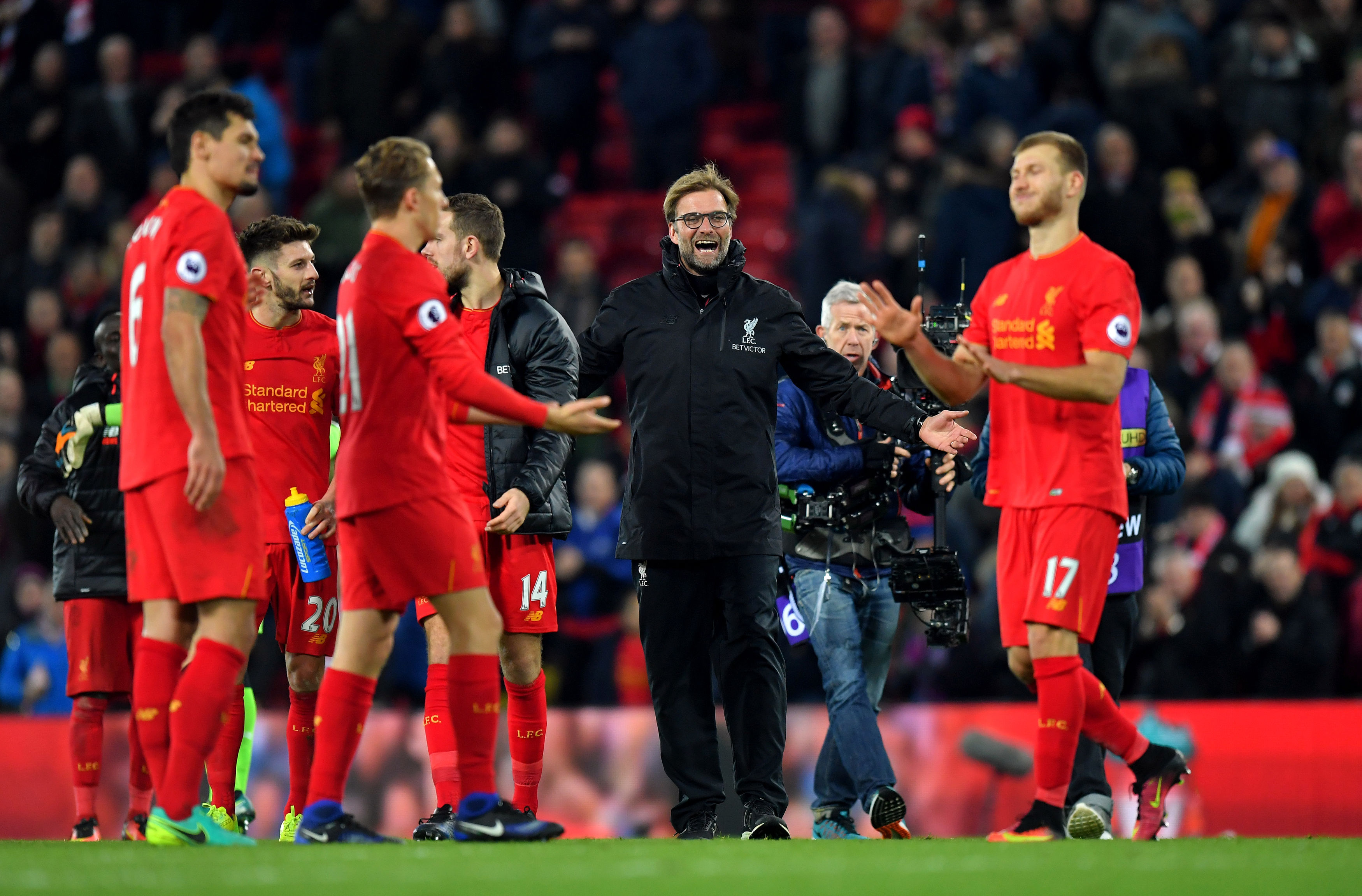 Liverpool manager Jurgen Klopp, center, celebrates with his players after the English Premier League soccer match Liverpool against Manchester City at Anfield, Liverpool, England, Saturday, Dec. 31, 2016. AP