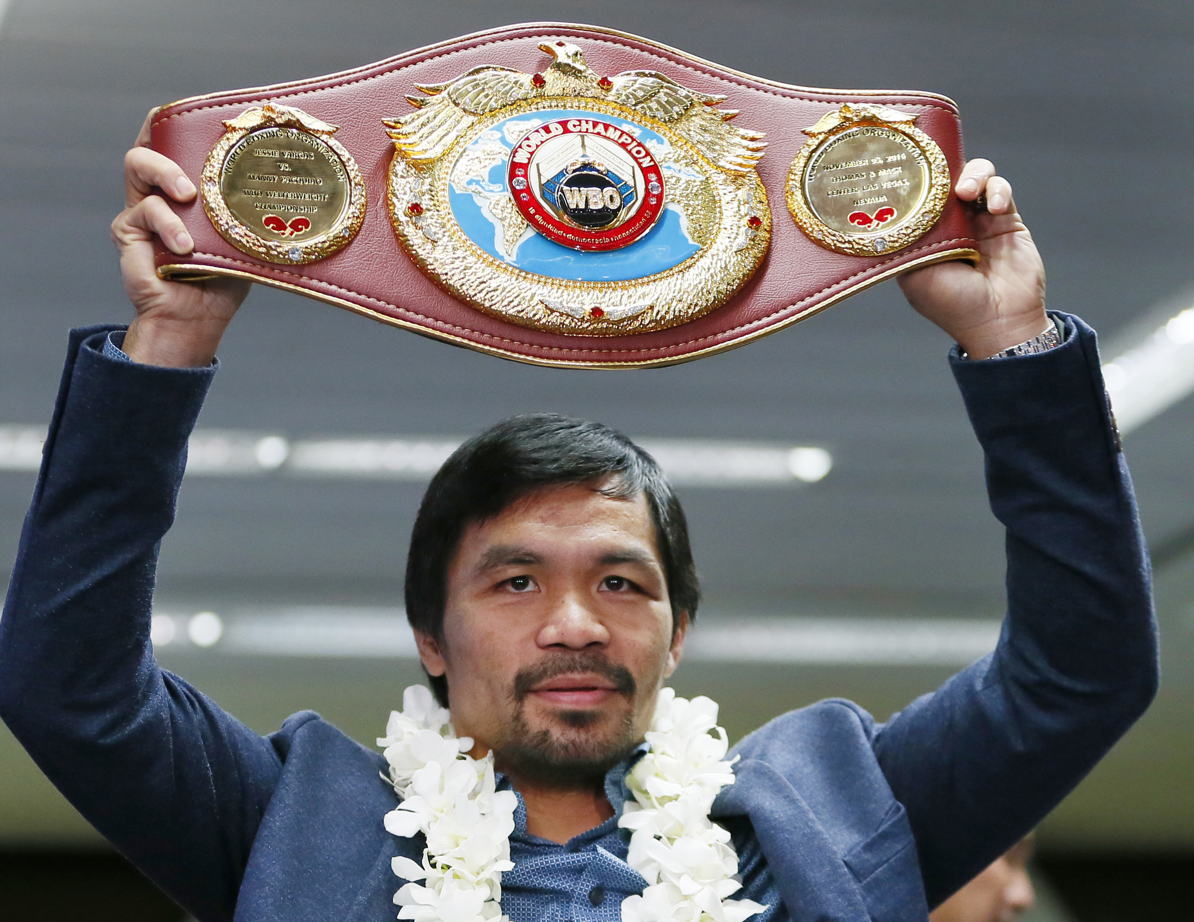 Filipino boxer Manny Pacquiao raises his WBO welterweight championship belt during a news conference upon arrival at the Ninoy Aquino International Airport in Pasay city, southeast of Manila, Philippines. Pacquiao, 38, will add another fight to his long career resume when he takes on Australian welterweight Jeff Horn on April 23 at a venue to be decided. (AP Photo/Bullit Marquez, File)