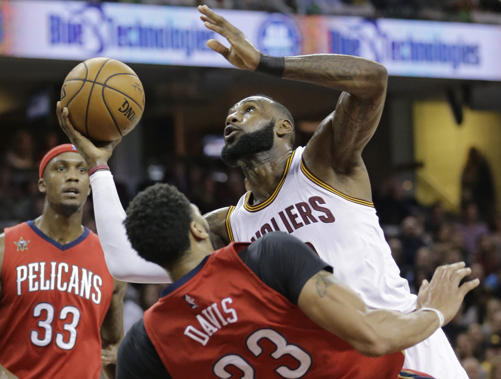Cleveland Cavaliers' LeBron James, right, is called for an offensive foul against New Orleans Pelicans' Anthony Davis in the first half of an NBA basketball game, Monday, Jan. 2, 2017, in Cleveland. (AP Photo/Tony Dejak)