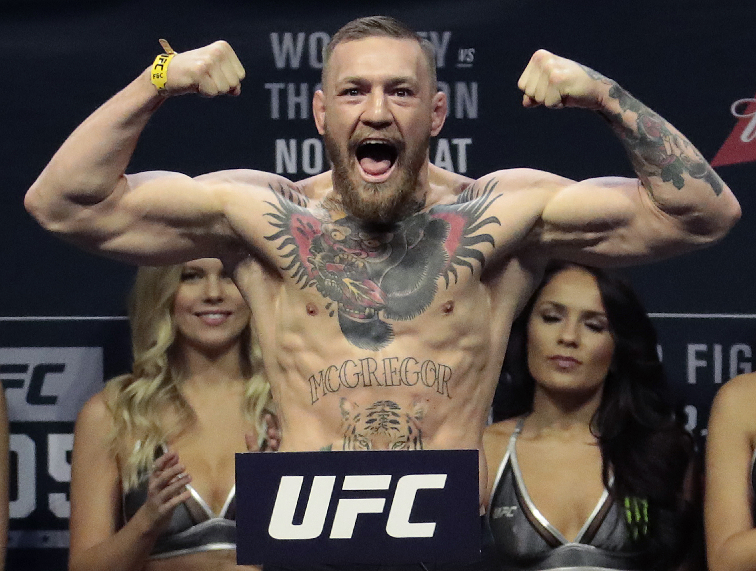 FILE - In this Friday, Nov. 11, 2016, file photo, Conor McGregor stands on a scale during the weigh-in event for his fight against Eddie Alvarez in UFC 205 mixed martial arts at Madison Square Garden in New York. Floyd Mayweather Jr. wants attention more than he wants a fight. And, really, let's be truthful here. It wouldn't be much of a fight if Mayweather and Conor McGregor met in a boxing ring. (AP Photo/Julio Cortez, File)