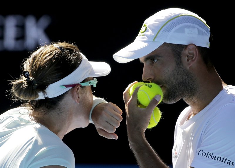 Abigail Speers of the US and Juan Sebastian Cabal of Colombia talk tactics in their mixed doubles' final against India's Sania Mirza and Ivan Dodig at the Australian Open tennis championships in Melbourne, Australia, Sunday, Jan. 29, 2017. (AP Photo/Aaron Favila)