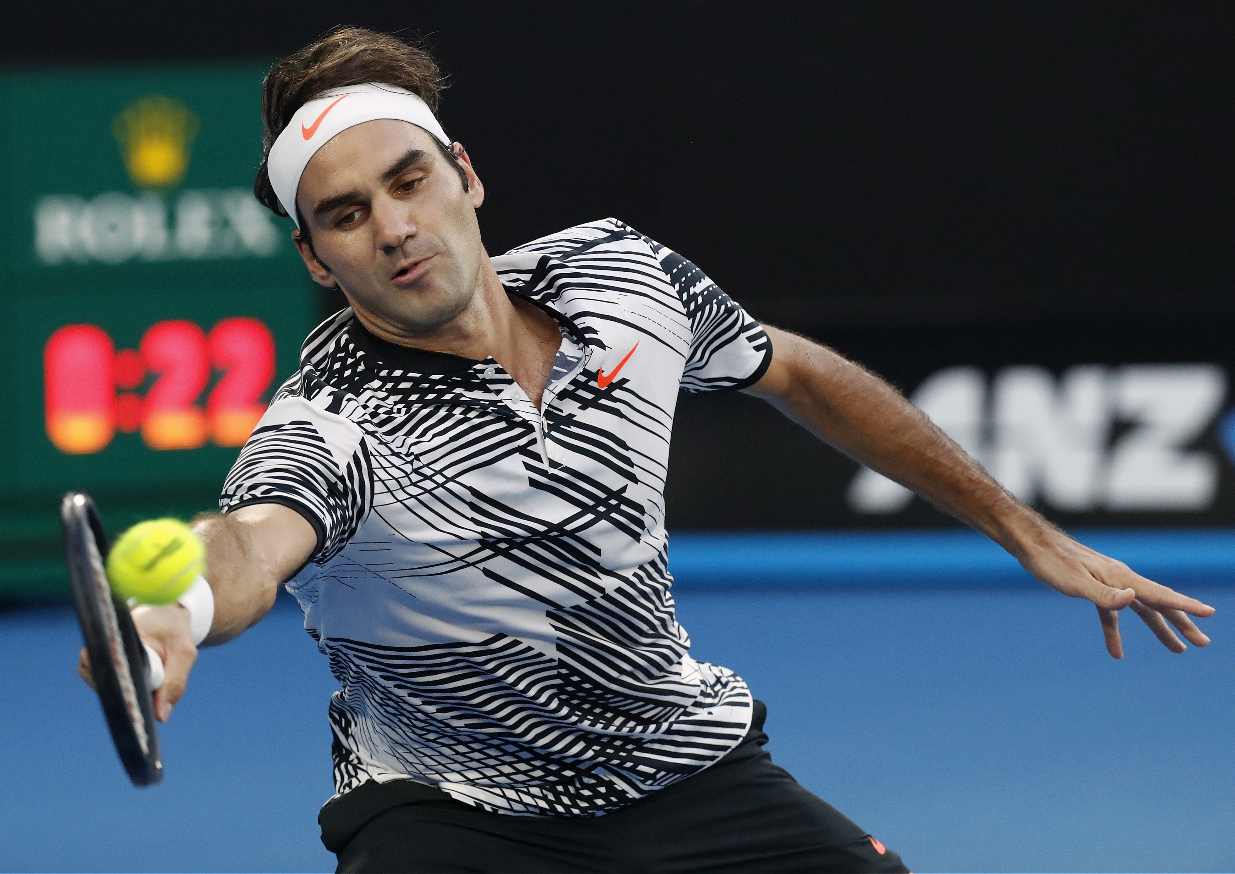 Switzerland's Roger Federer reaches to play a forehand to Spain's Rafael Nadal during the men's singles final at the Australian Open tennis championships in Melbourne, Australia, Sunday, Jan. 29, 2017. (AP Photo/Kin Cheung)