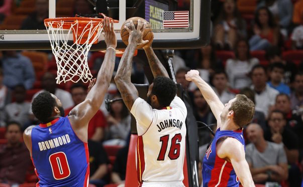 Miami Heat forward James Johnson (16) goes up to shoot against Detroit Pistons center Andre Drummond (0) and forward Jon Leuer during the first half of an NBA basketball game, Saturday, Jan. 28, 2017, in Miami. (AP Photo/Wilfredo Lee) 
