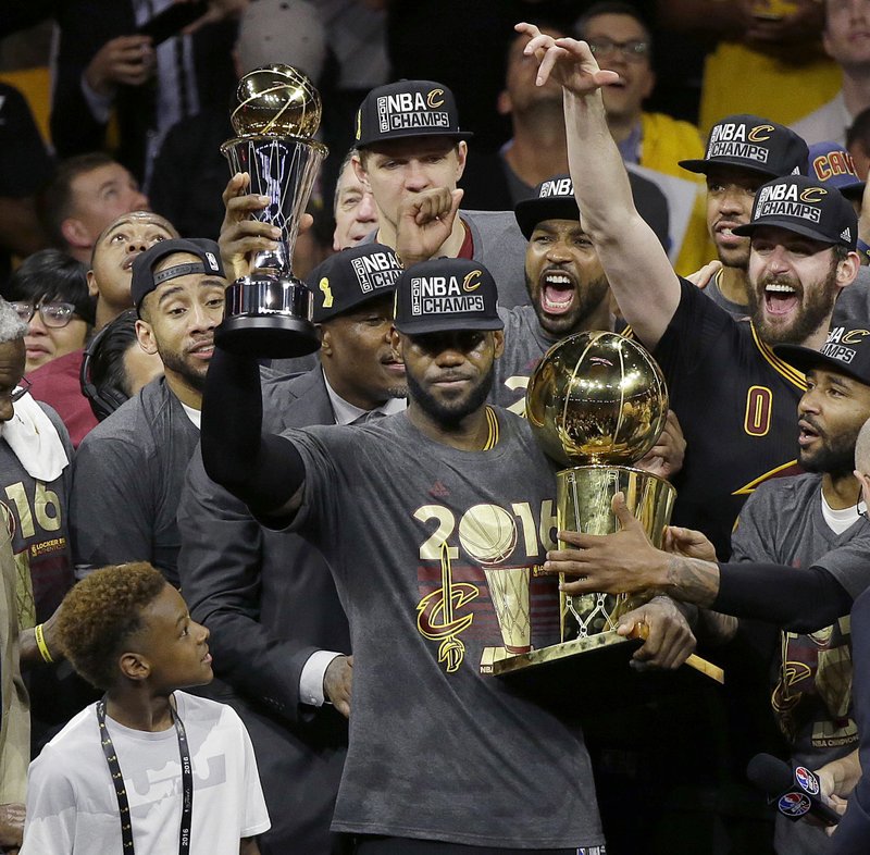 FILE - In this June 19, 2016, file photo, Cleveland Cavaliers forward LeBron James, center, celebrates with teammates after Game 7 of basketball's NBA Finals against the Golden State Warriors in Oakland, Calif. The Cavaliers won 93-89. AP