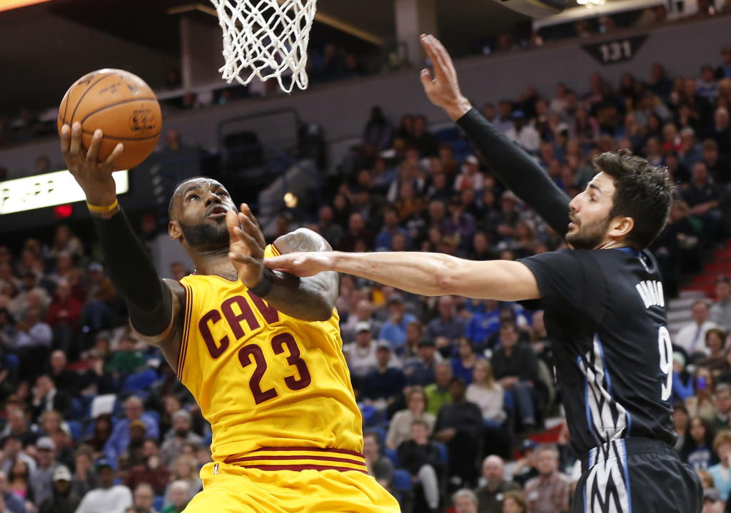 Cleveland Cavaliers' LeBron James, lays up as Minnesota Timberwolves' Ricky Rubio of Spain defends during the second half of an NBA basketball game Tuesday, Feb. 14, 2017, in Minneapolis. The Cavaliers won 116-108. James and Kyrie Irving led their team's scoring with 25 points each. (AP Photo/Jim Mone)